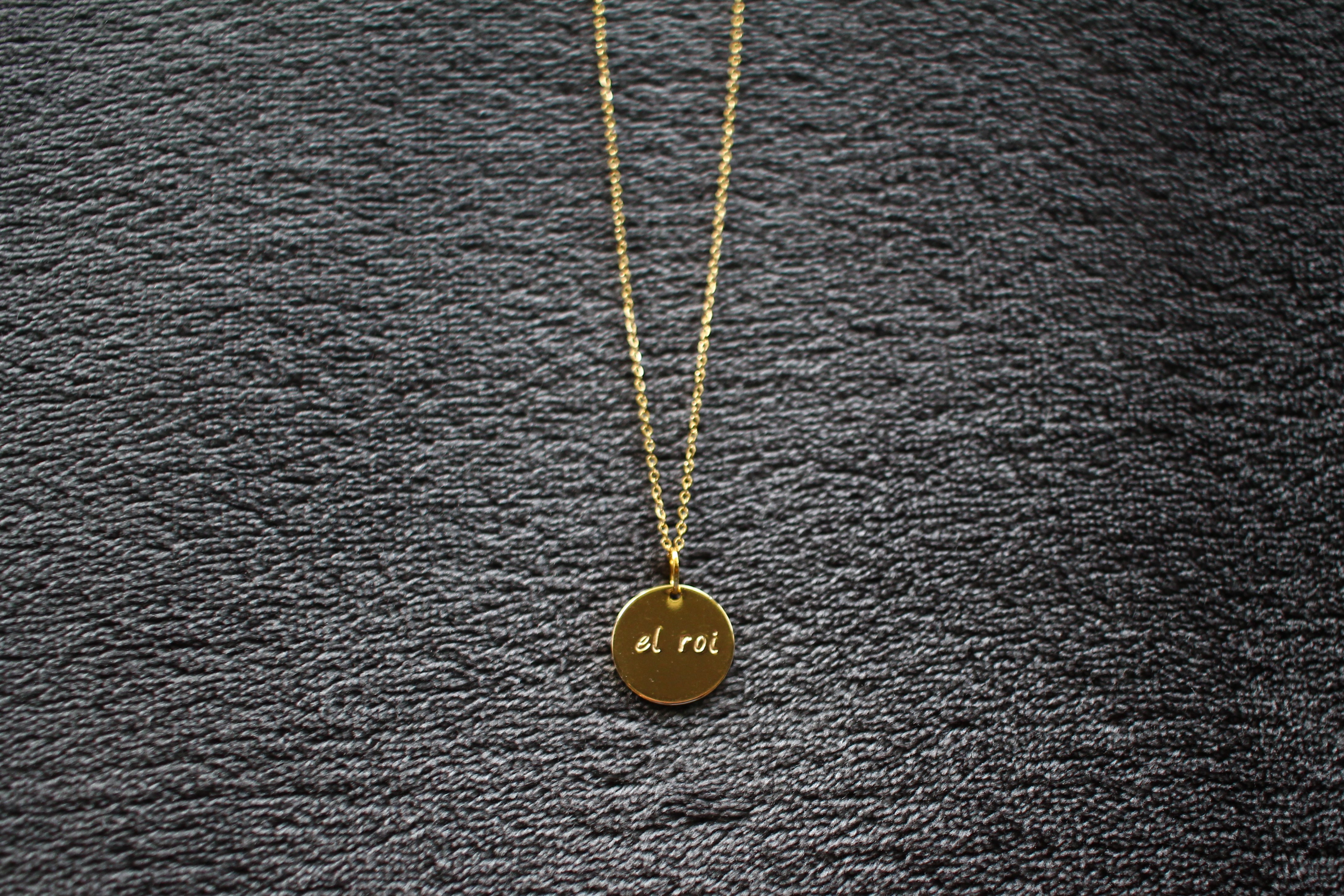 Gold necklace with 'El Roi' written on it